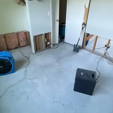 Extraction crew pulling floodwater from a living room floor